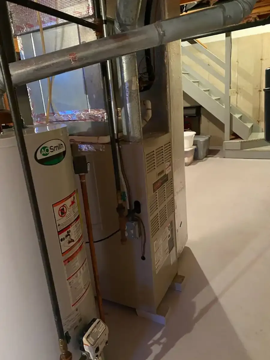 Water heater installed alongside a residential furnace